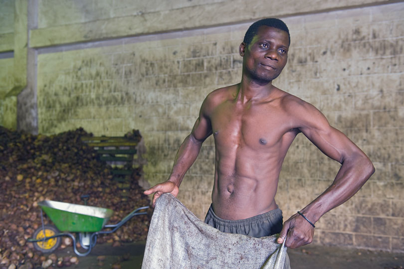 A worker in the factory empties &lt;p&gt;the bags with copra into …