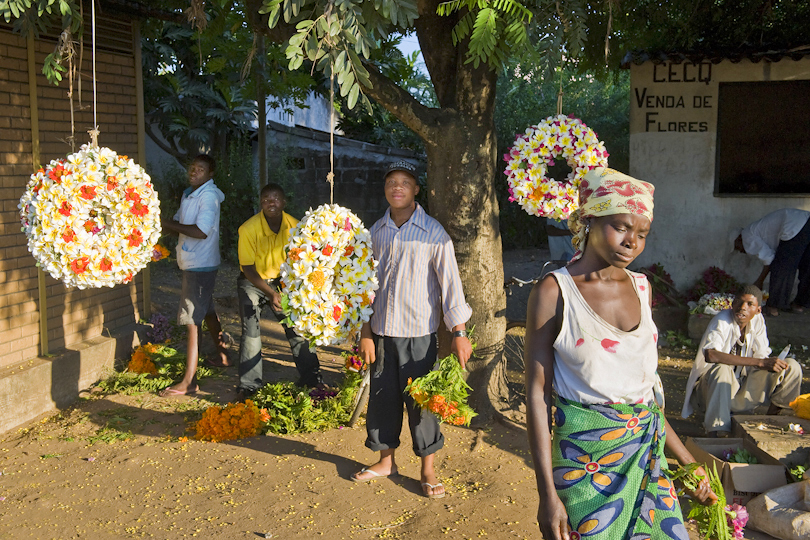 People selling coronals at the entrance of a  cemetery